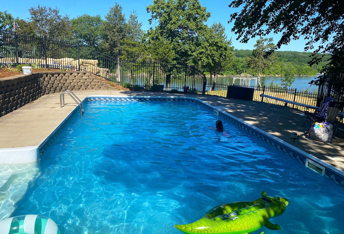 Private outdoor swimming pool surrounded by trees